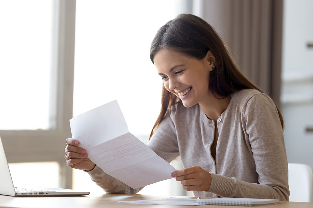 Excited woman reading letter