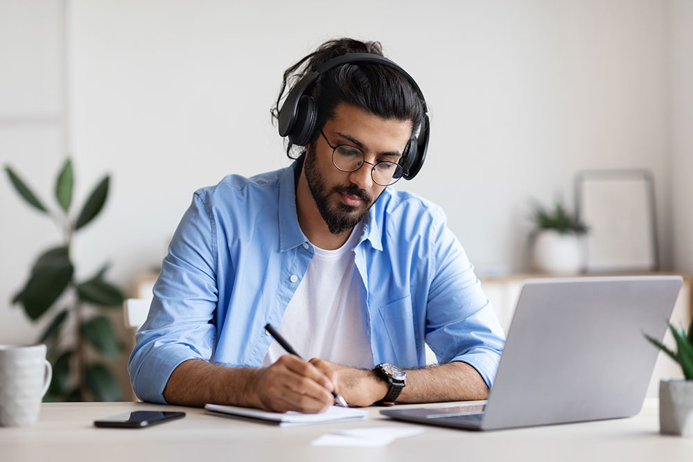 Man concentrated writing notes