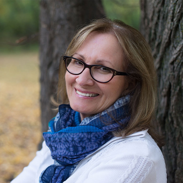 Janet Steep smiling with trees in background