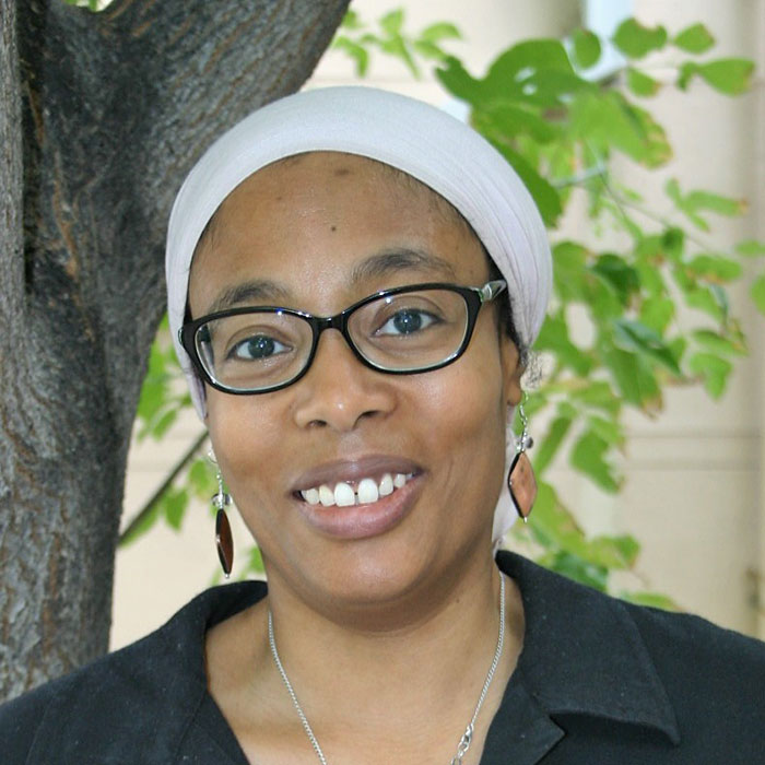 Jennifer Nembhard smiling with trees in background