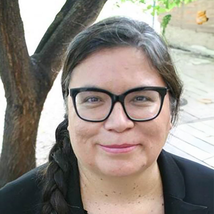 Lisa Forbes smiling with tree in background