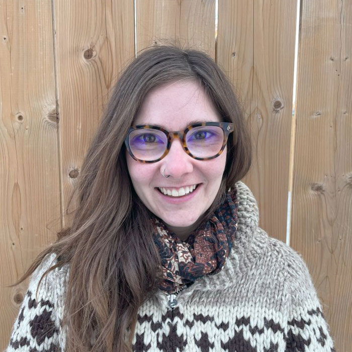 Natalie Wiebe smiling with fence in background