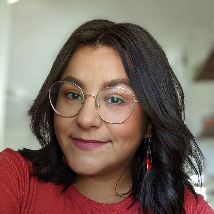 Close-up of Sara Bennet smiling wearing eye glasses