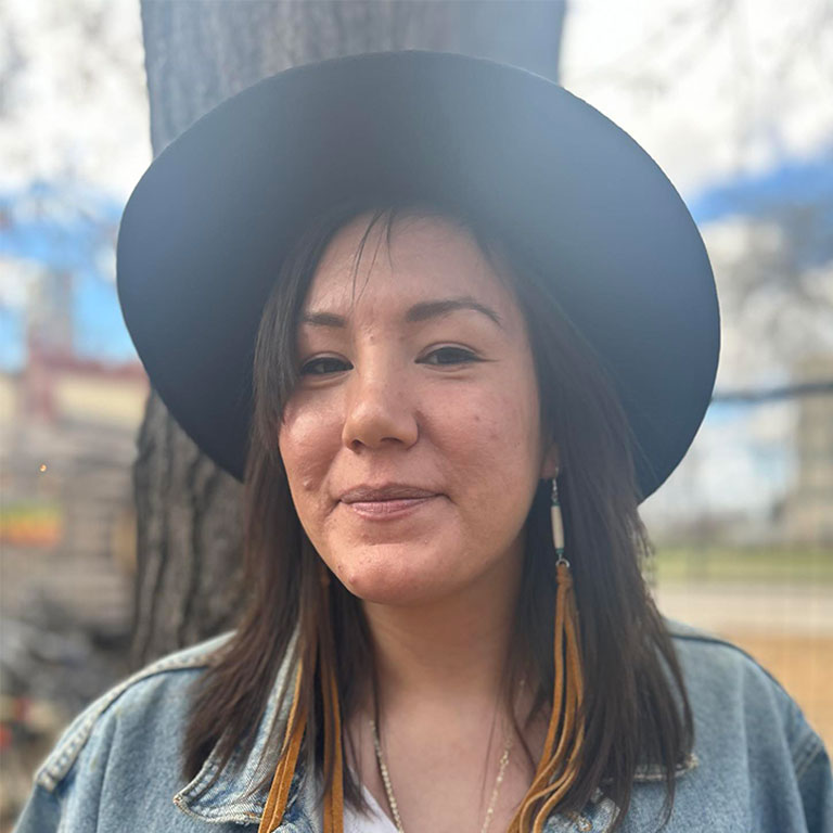 Sherise Fleury standing outside with trees in the background